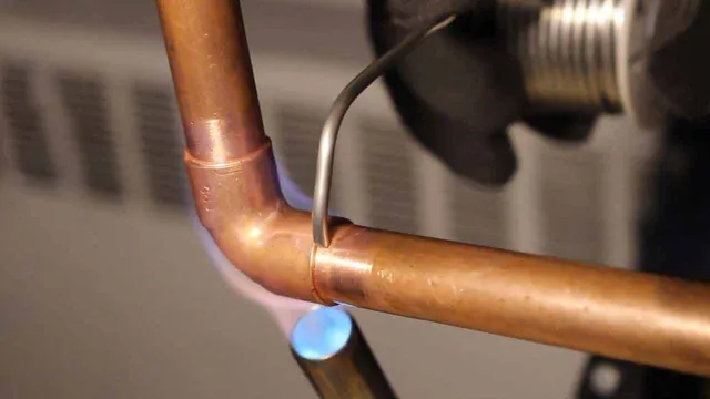 Resoldering copper pipe joint using torch for plumbing repair