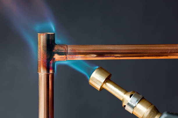 Soldering copper plumbing pipes using torch for water supply and HVAC systems
